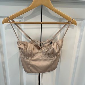 Crop top featuring adjustable straps and cinch drawstring cross cross back.